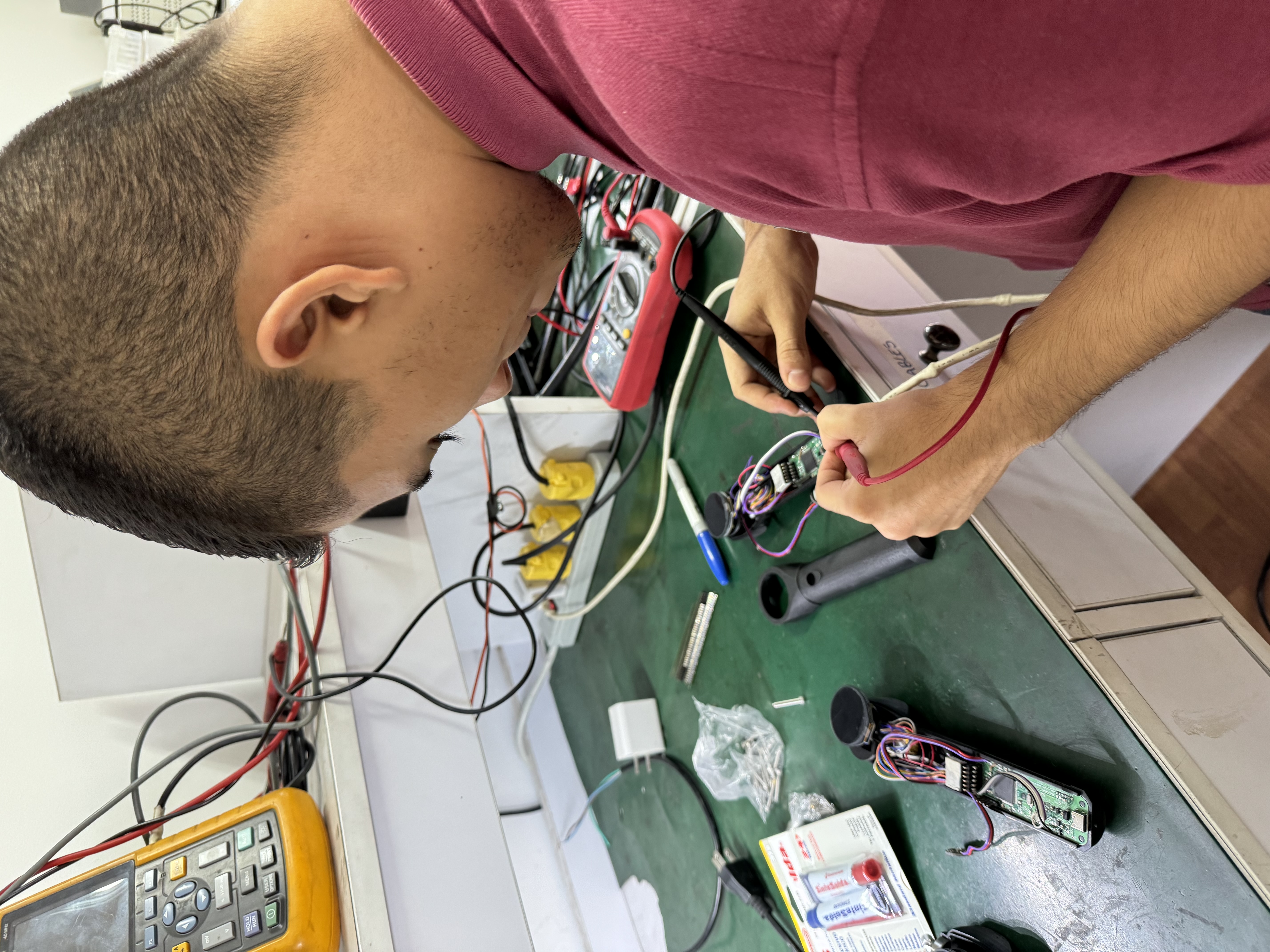 Engineer soldering a custom PCB at the workbench