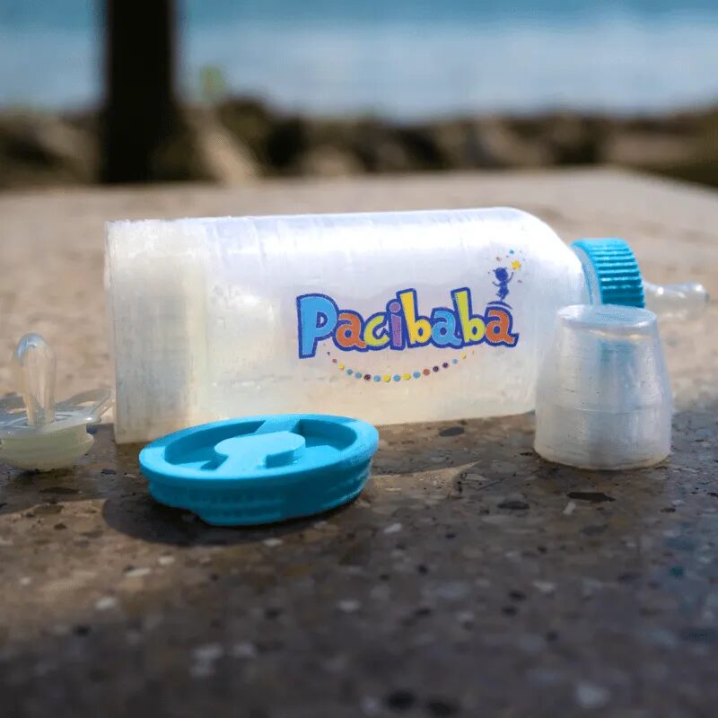 Pacibaba baby bottle with the base open to show the pacifier compartment