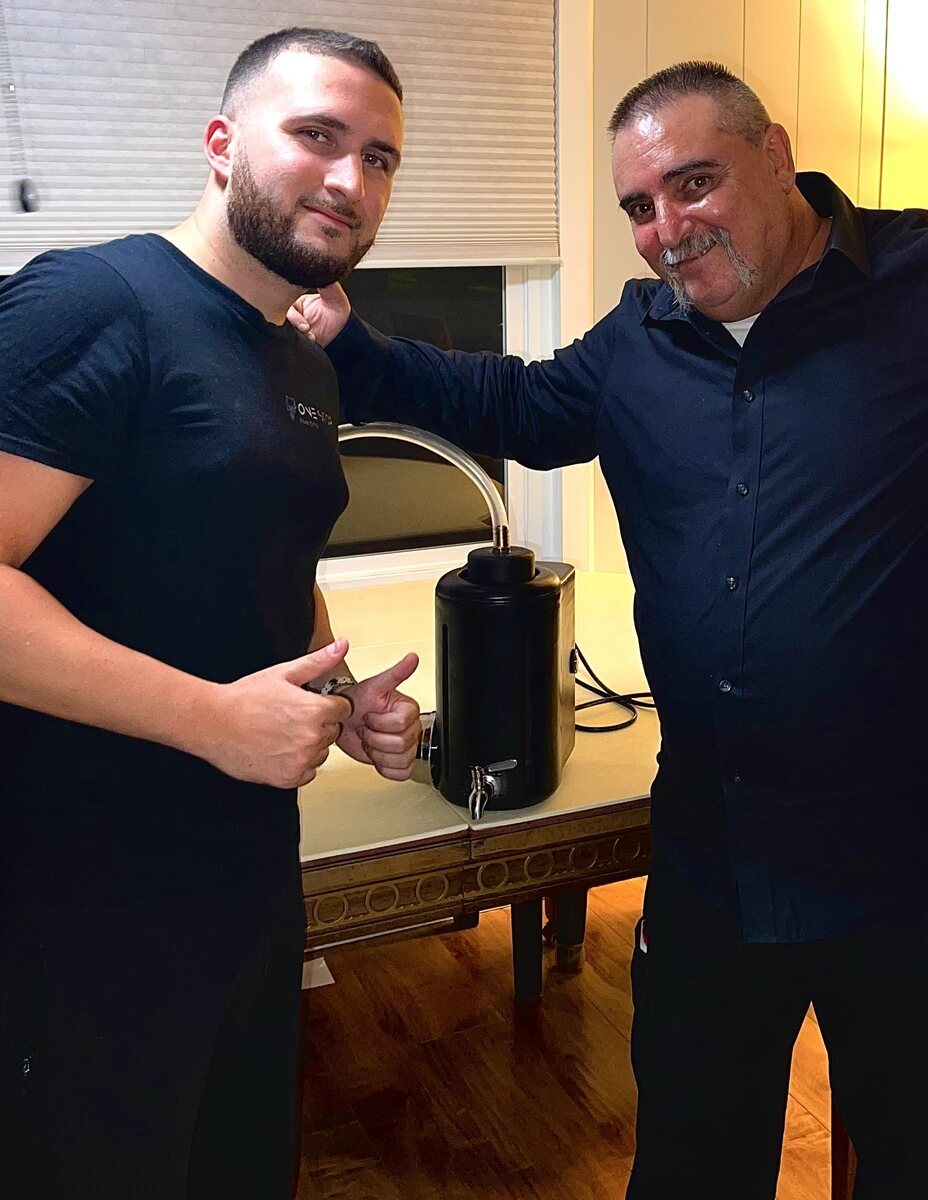 Two collaborators standing beside a countertop product prototype